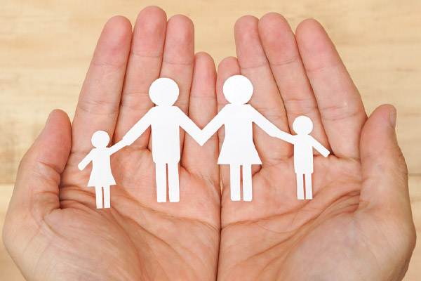 hands holding family depicting heating system safety